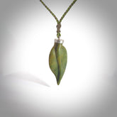 This picture shows a leaf shaped pendant, hand carved from New Zealand flower jade. It has a silver cap with loop on the top for a cord or a chain. We will provide this with an adjustable plaited cord.